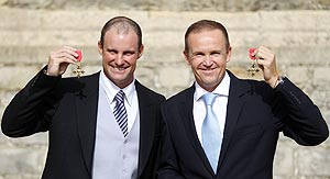 England Test captain Andrew Strauss and coach Andy Flower pose with their OBE medals