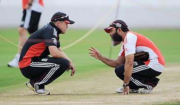 England coach Andy Flower speaks with spin bowling coach Mushtaq Ahmed at a nets session