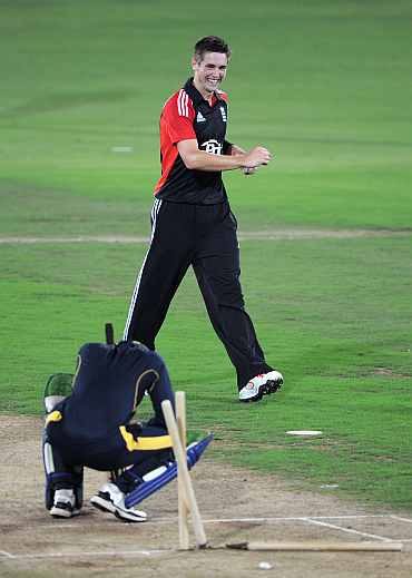Chris Woakes celebrates after picking the wicket of Ibrahim Khaleel