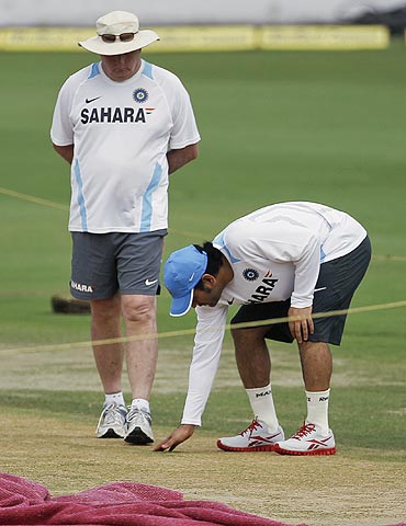 India's captain Mahendra Singh Dhoni (right) and coach Duncan Fletcher inspect the pitch in Hyderabad on Thursday