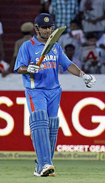 MS Dhoni raises the bat after getting to fifty