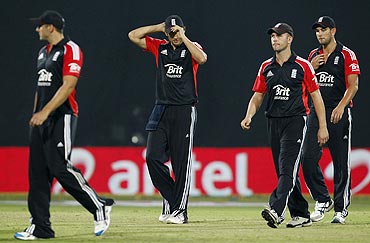England's captain Alastair Cook (2nd from left) walks off the field with his team
