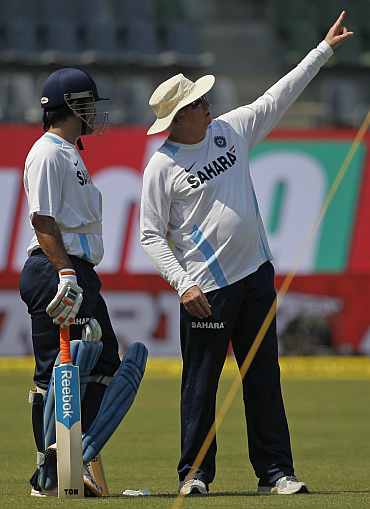 MS Dhoni speaks to coach Duncan Fletcher during a practice session in Mumbai