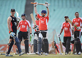 England captain Graeme Swann celebrates after hitting a six during a nets session at Eden Gardens on Friday