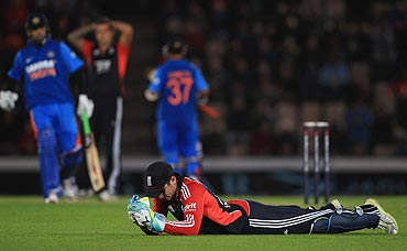Craig Kieswetter of England looks on as a ball goes to the boundary off Rahane's bat