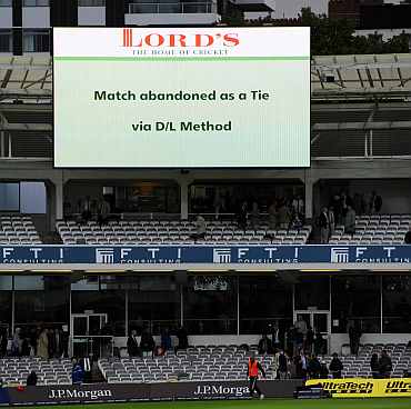 The big screen displays the decision to abandon the match as a tie via the Duckworth-Lewis method