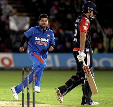 Virat Kohli celebrates after picking up the wicket of Alastair Cook
