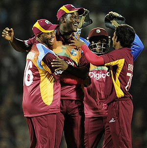 West Indies players celebrate with captain Darren Sammy after beating England in the 2nd T20 on Sunday