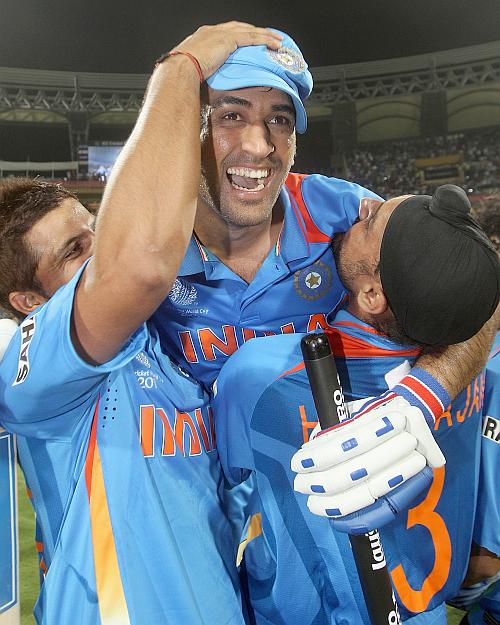 MS Dhoni (centre) of India celebrates victory with team mates Suresh Raina (left) and Harnhajan Singh after the 2011 ICC World Cup