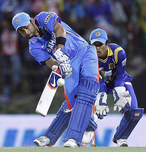 India's Virat Kohli (L) plays a shot during their Twenty20 match against Sri Lanka in Pallekele