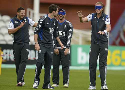 England's Tim Bresnan and James Anderson guide a blindfolded Prior and Broad during training session in London