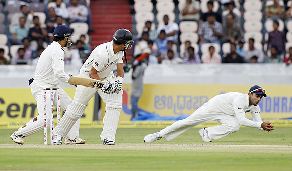 New Zealand's captain Ross Taylor (centre) watches as India's Virat Kohli (right) dives to takes a catch to dismiss him off the bowling of R Ashwin