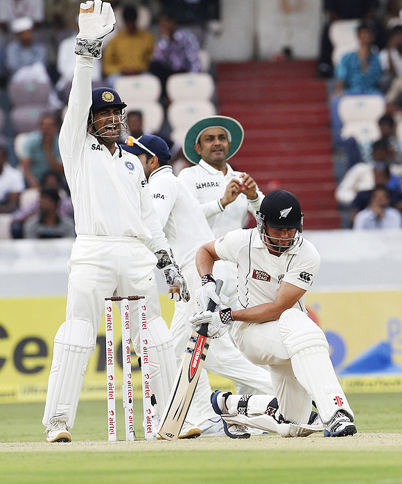 Mahendra Singh Dhoni (left) makes a successful LWB appeal for the wicket of New Zealand's Daniel Flynn (right) off the bowling of R Ashwin