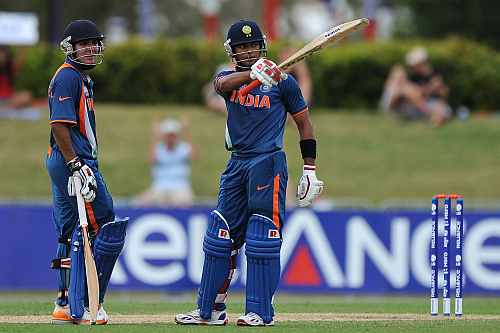 Unmukt Chand (R) of India celebrates reaching his century during the 2012 ICC U19 Cricket World Cup Final between Australia and India