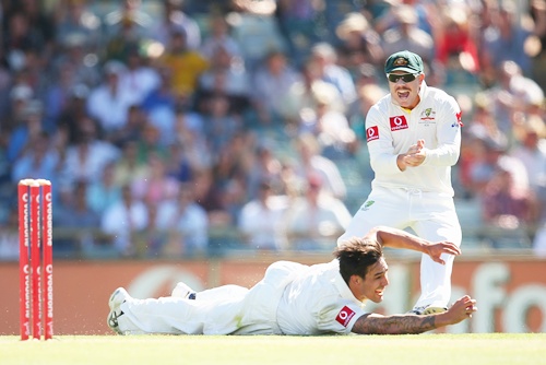 Mitchell Johnson of Australia catches out Alviro Petersen of South Africa