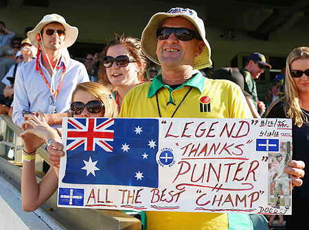 A fan poses with a message for Ricky Ponting during day four of the Third Test between Australia and South Africa on Monday