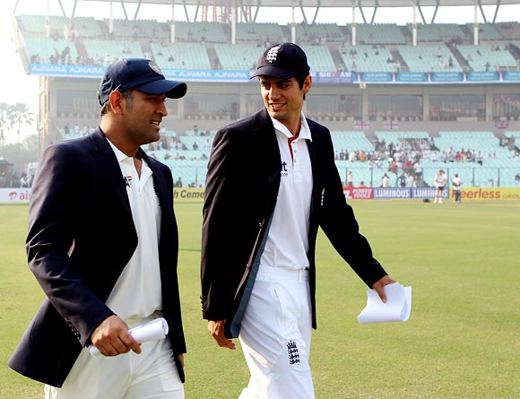 India captain Mahendra Singh Dhoni walks out for the toss with England's captain Alastair Cook