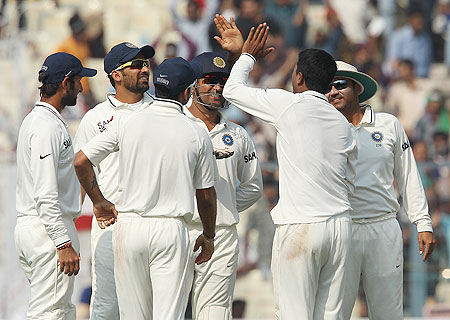 Indian players celebrate after the dismissal of Jonathan Trott