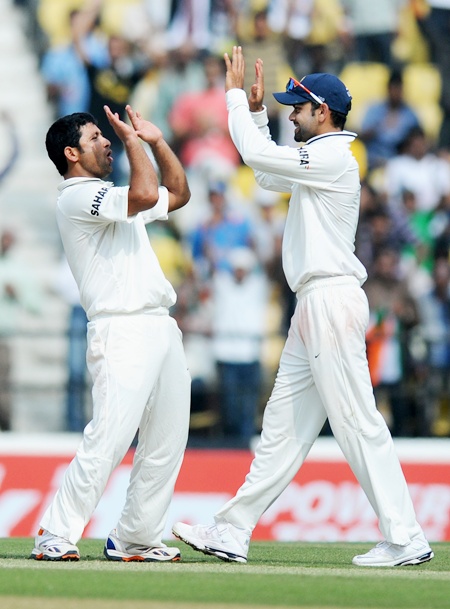 Piyush Chawla celebrates with Virat Kohli after claiming the wicket of Joe Root