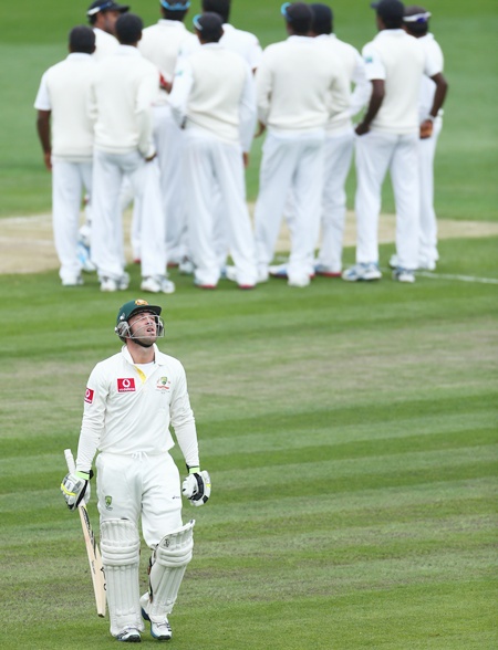 Phillip Hughes of Australia walks from the ground after he was bowled