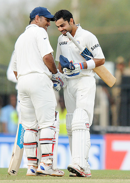 MS Dhoni captain of India congratulates teammate Virat Kohli of India as the latter scores a century