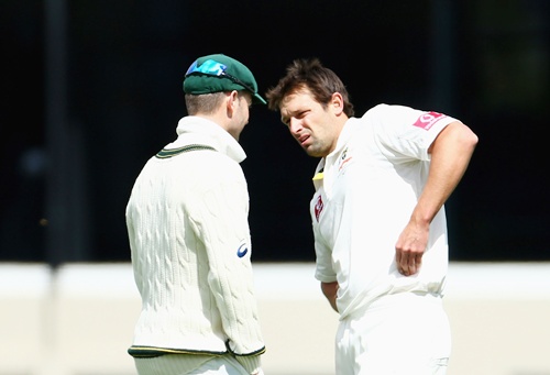 Australian captain Michael Clarke talks with bowler Ben Hilfenhaus
