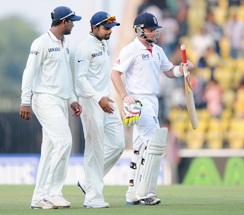 Pragyan Ojha, Virat Kohli of India and Ian Bell of England walk back at the end of days play