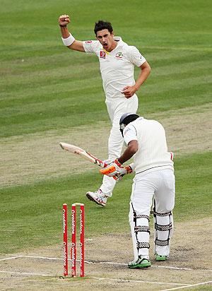 Australia'S Mitchell Starc celebrates after dismissing Sri Lanka's Dimuth Karunaratne on day four of the First Test on Monday