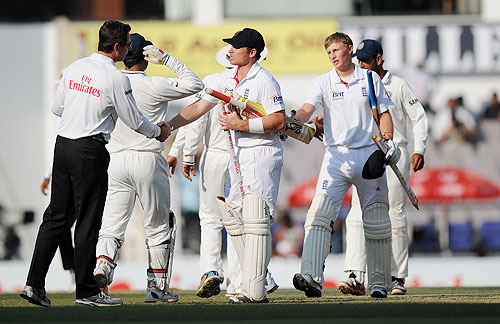 Ian Bell of England and Joe Root greet the Indian team and the umpires after the match ended in a draw on Monday
