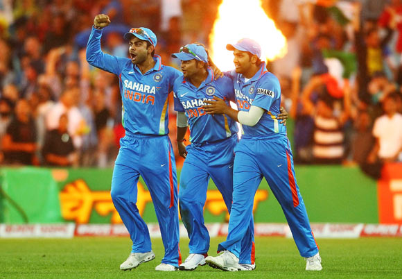 Suresh Raina of India is congratulated by tem mates after catching David Warner of Australia during the International Twenty20 match between Australia and India