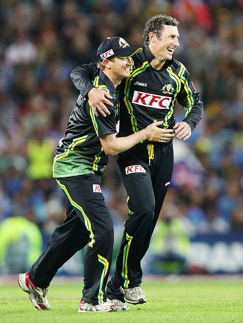 David Hussey (right) celebrates with captain George Bailey after taking the wicket of Gautam Gambhir on Wednesday