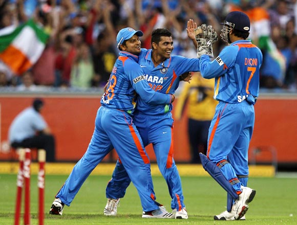 The Indian players celebrate the run out of George Bailey