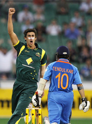 Mitchell Starc of Australia celebrates the wicket of Sachin Tendulkar of India during game one of the Commonwealth Bank tri-series
