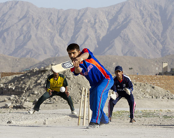 A batsman tries to hit the ball during a neighborhood cricket game