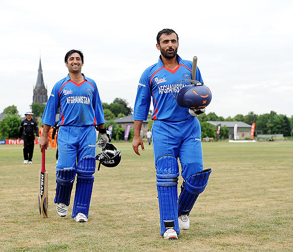 Nowroz Mangal (right) and Asghar Salakhail of Afghanistan leave the field after beating Netherlands during the ICC World Cricket League Division One match