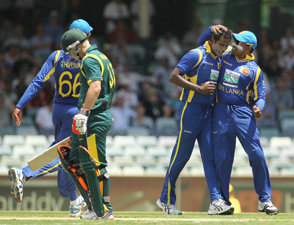Angelo Matthews (2nd R) of Sri Lanka celebrates with team mate Mahela Jayawardene after taking the wicket of David Warner of Australia during game three