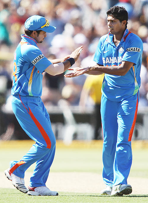 Umesh Yadav (right) of India celebrates after getting the wicket of Peter Forrest