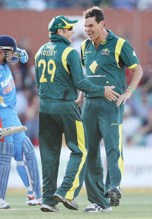 David Hussey (left) and Clint McKay (right) of Australia celebrate after McKay got the wicket of Virender Sehwag