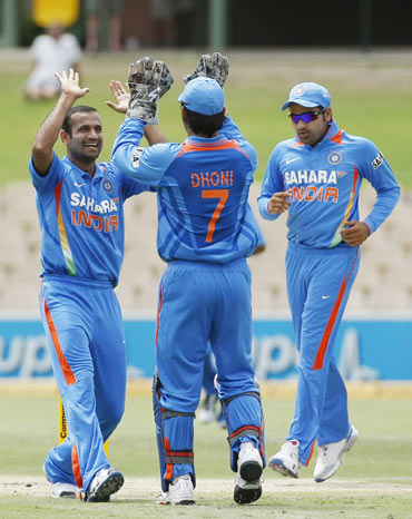 Irfan Pathan (L) of India celebrates the wicket of Tillakaratne Dilshan of Sri Lanka with captain MS Dhoni (C) during their one-day international cricket match in Adelaide