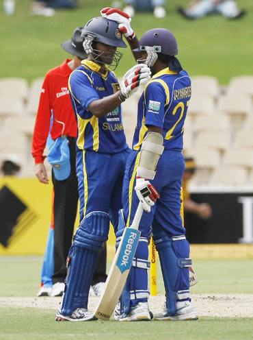 Dinesh Chandimal (L) is congratulated by captain Mahela Jayawardene (R) on his 50