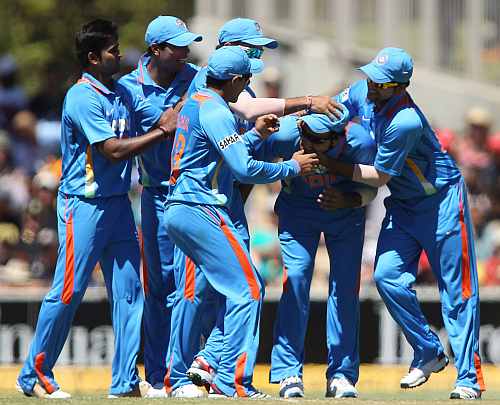 Indian team celebrates after a fall of a wicket