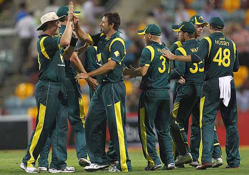 Australian players celebrate after winning the match against India in Brisbane
