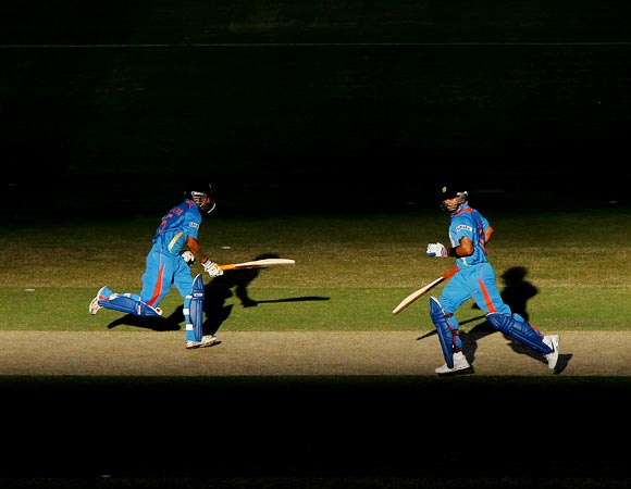 Gautam Gambhir (left) and Virat Kohli run between the wickets