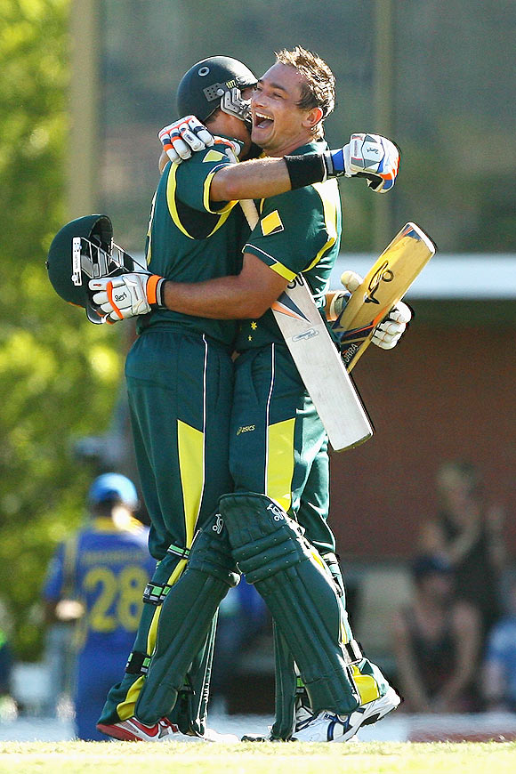 Peter Forrest celebrates with team-mate Michael Hussey after scoring his maiden century