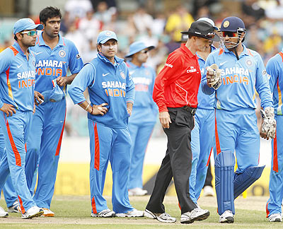 India's captain MS Dhoni (right) remonstrates to umpire Billy Bowden after Australia's David Hussey fended off a return with his hand during their one-day international on Sunday