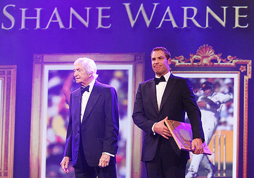 Shane Warne (right) stands with the legendary Richie Benaud