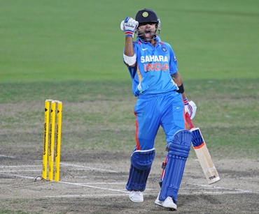 Virat Kohli celebrates after hitting the winning runs during the tri-series ODI between India and Sri Lanka at Bellerive Oval on Tuesday