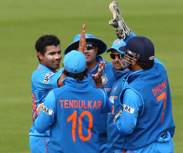 The Indian team celebrates the fall of a Sri Lankan wicket