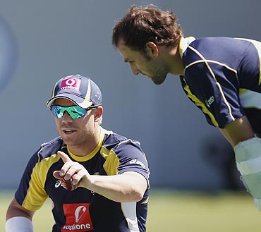Australia's Nathan Lyon (right) chats with teammate David Warner in the nets during a practice session in Sydney on Monday