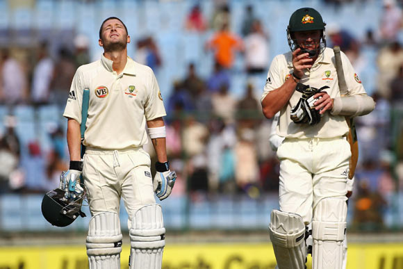 Michael Clarke (L) of Australia shows his relief alongside Brett Lee after reaching his century during day four of the Third Test match between India and Australia in Ferozshah Kotla